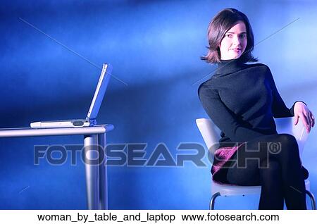 Woman by table and laptop View Large Photo Image Stock Photography - Woman by table and laptop. Fotosearch