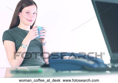 Stock Image - Woman coffee at desk. Fotosearch