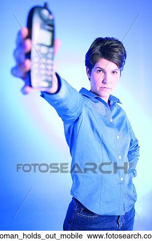 Stock Image - Woman holds out mobile. Fotosearch