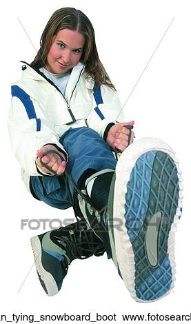 Stock Photograph - Woman tying snowboard boot. Fotosearch