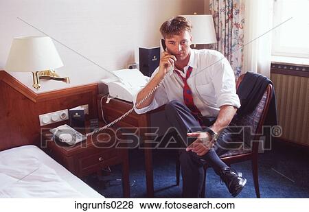 Businessman Making a Phone Call in a Hotel Room View Large Photo Image Stock Photo - Businessman Making a Phone Call in a Hotel Room. Fotosearch