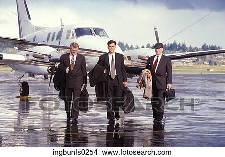 Picture - Businessmen Getting off a Plane. Fotosearch