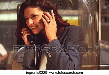 Woman On Two Phones At Once View Large Photo Image Stock Photo - Woman On Two Phones At Once. Fotosearch