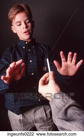 Stock Image - Boy Refusing a Cigarette. Fotosearch