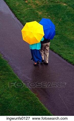 Couple With Umbrellas View Large Photo Image Stock Photo - Couple With Umbrellas. Fotosearch