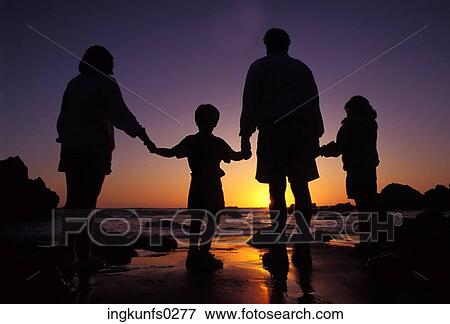 Family Standing on the Beach at Sunset View Large Photo Image Stock Photo - Family Standing on the Beach at Sunset. Fotosearch