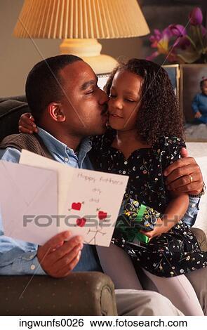 Stock Photograph - Father Receiving Card From Daughter. Fotosearch