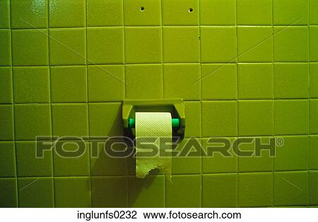 Stock Image - Green Bathroom Tile and Toilet Paper on Roll. Fotosearch