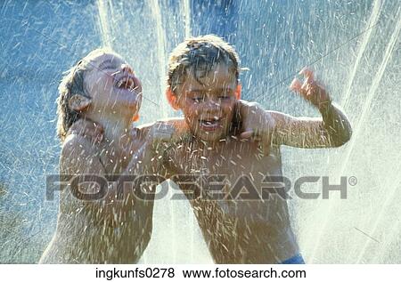 Kids Playing in a Sprinkler View Large Photo Image Stock Photo - Kids Playing in a Sprinkler. Fotosearch