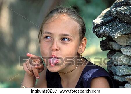 Stock Photo - Little Girl Sticking Out Her Tongue. Fotosearch
