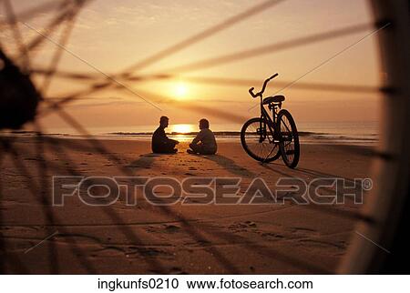 Looking Through Bike Wheel at Couple on Beach View Large Photo Image Stock Image - Looking Through Bike Wheel at Couple on Beach. Fotosearch