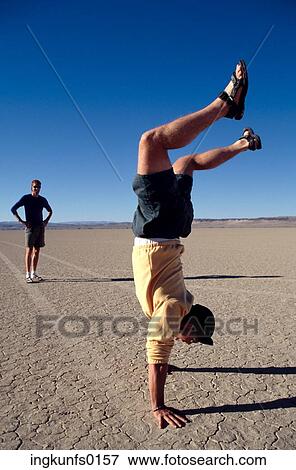 Stock Photo - Men Goofing Around in Desert. Fotosearch