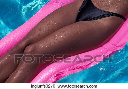 Woman Sunbathing on Raft in Pool View Large Photo Image Stock Image - Woman Sunbathing on Raft in Pool. Fotosearch