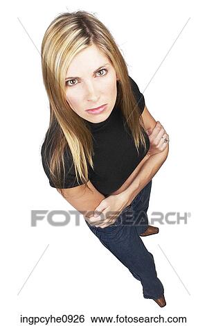 Angry young blond woman standing with her arms crossed in front of her View Large Photo Image Stock Photograph - Angry young blond woman standing with her arms crossed in front of her . Fotosearch