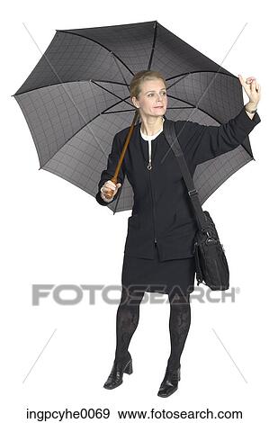 Stock Photo - Businesswoman hailing cab under umbrella . Fotosearch