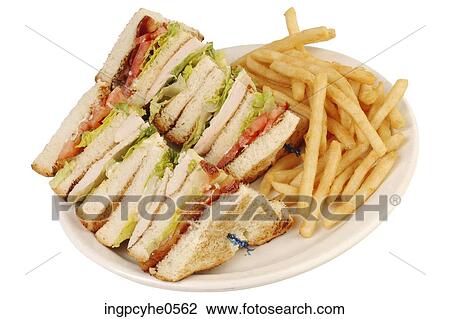 Stock Image - Clubhouse sandwich and French fries . Fotosearch