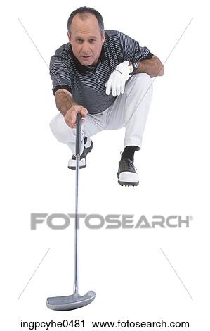Stock Image - Golfer lining up putt . Fotosearch