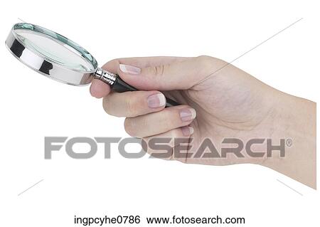 Stock Photograph - Hand holding Magnifying Glass BE . Fotosearch