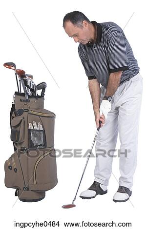 Man putting beside golf bag View Large Photo Image Picture - Man putting beside golf bag . Fotosearch