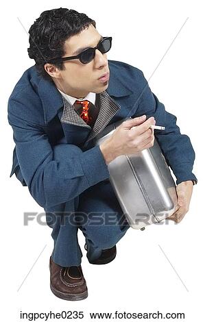 man with briefcase crouching and having cigarette View Large Photo Image Stock Photography - man with briefcase crouching and having cigarette . Fotosearch
