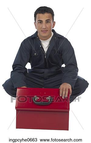 Stock Image - Mechanic kneeling over open toolbox . Fotosearch