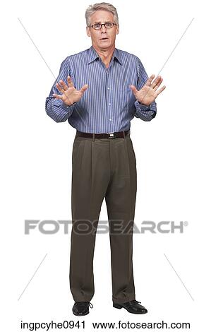 Stock Image - Middle aged man making a stop gesture with his hands . Fotosearch
