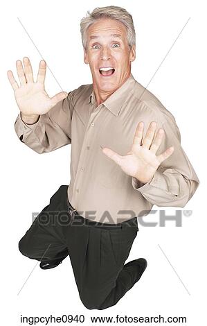 Stock Image - Middle aged man making an excited expression . Fotosearch