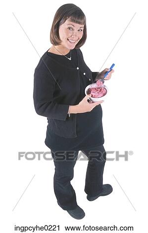 Stock Image - pregnant woman eating . Fotosearch