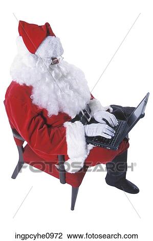 Santa Claus typing on laptop computer View Large Photo Image Stock Image - Santa Claus typing on laptop computer . Fotosearch