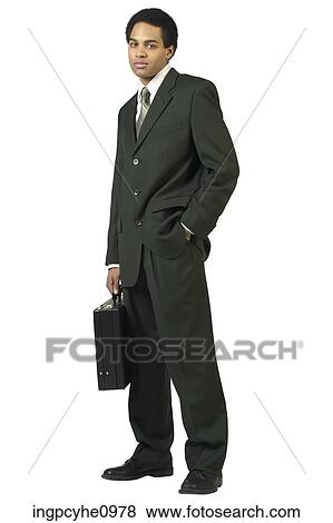 Serious businessman in black suit with briefcase View Large Photo Image Stock Photo - Serious businessman in black suit with briefcase. Fotosearch