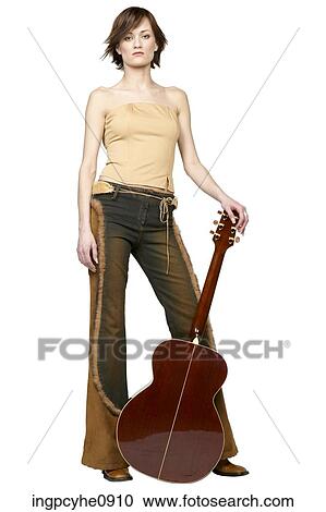 Serious woman leaning on acoustic guitar View Large Photo Image Stock Image - Serious woman leaning on acoustic guitar. Fotosearch