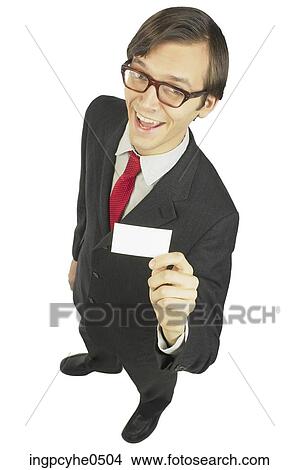 Smiling businessman holding business card View Large Photo Image Picture - Smiling businessman holding business card . Fotosearch