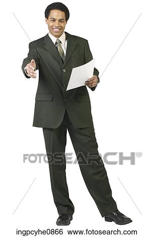 Smiling businessman holding paper and offering hand View Large Photo Image Stock Photograph - Smiling businessman holding paper and offering hand. Fotosearch