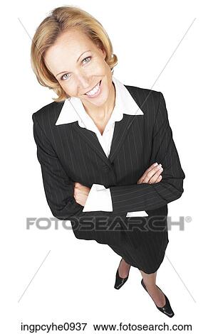 Smiling middle aged business woman standing with her arms crossed View Large Photo Image Stock Photo - Smiling middle aged business woman standing with her arms crossed . Fotosearch