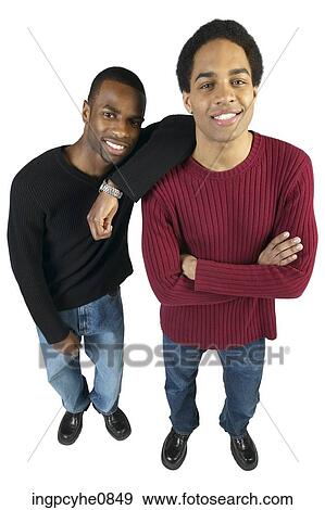 Two young men leaning against each other and smiling View Large Photo Image Stock Photo - Two young men leaning against each other and smiling . Fotosearch