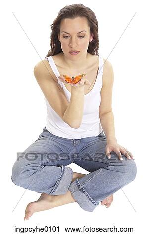Stock Image - Woman holding monarch butterfly . Fotosearch