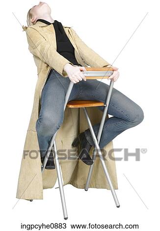 Woman sitting on a chair View Large Photo Image Stock Image - Woman sitting on a chair . Fotosearch