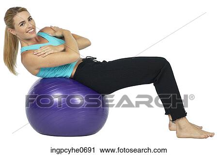 Stock Image - woman with exercise ball . Fotosearch