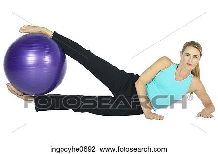 Stock Image - woman with exercise ball . Fotosearch