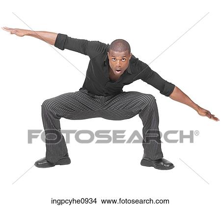 Young African American man kneeled over with his arms out to his sides View Large Photo Image Picture - Young African American man kneeled over with his arms out to his sides . Fotosearch