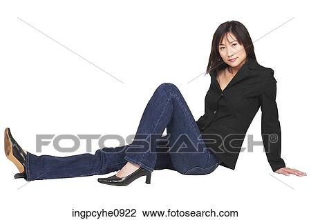 Young Asian woman sitting on the floor with her legs out in front of her View Large Photo Image Stock Image - Young Asian woman sitting on the floor with her legs out in front of her . Fotosearch