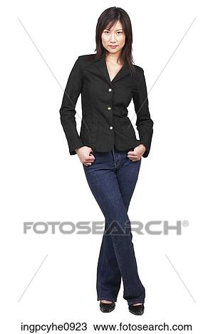 Stock Image - Young Asian woman standing with her hands in her pockets . Fotosearch