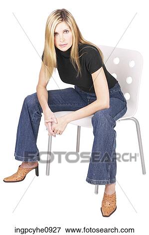 Young blonde woman sitting on a chair View Large Photo Image Stock Photo - Young blonde woman sitting on a chair . Fotosearch