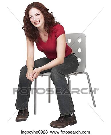 Stock Photo - Young brunette sitting on a chair . Fotosearch