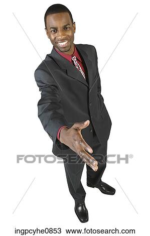 Stock Image - Young executive offering his hand for a handshake . Fotosearch