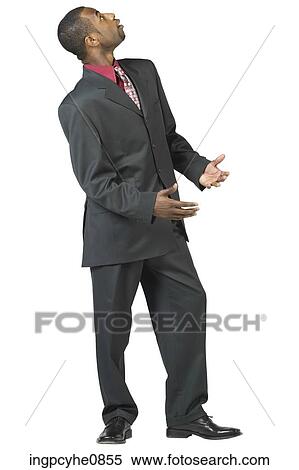 Young man looking upwards expectantly View Large Photo Image Stock Photography - Young man looking upwards expectantly. Fotosearch