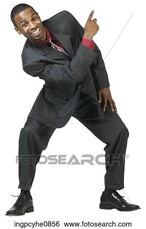 Young man pointing upwards and smiling View Large Photo Image Stock Photograph - Young man pointing upwards and smiling. Fotosearch