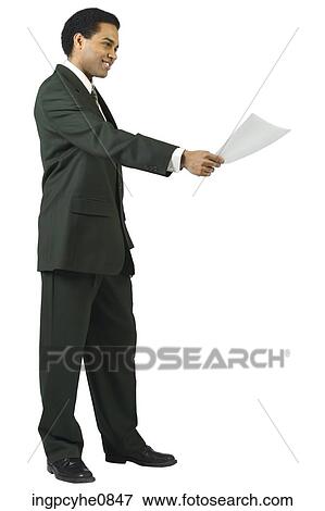 Young man smiling and holding out a memo View Large Photo Image Stock Photo - Young man smiling and holding out a memo . Fotosearch