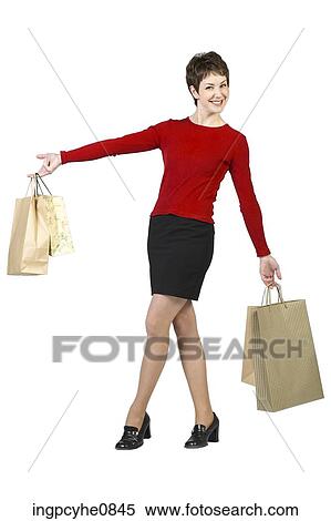 Young woman smiling and posing with shopping bags View Large Photo Image Stock Photography - Young woman smiling and posing with shopping bags . Fotosearch