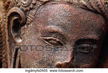 Stock Photography - Ancient Stone Carving of a Face. Fotosearch